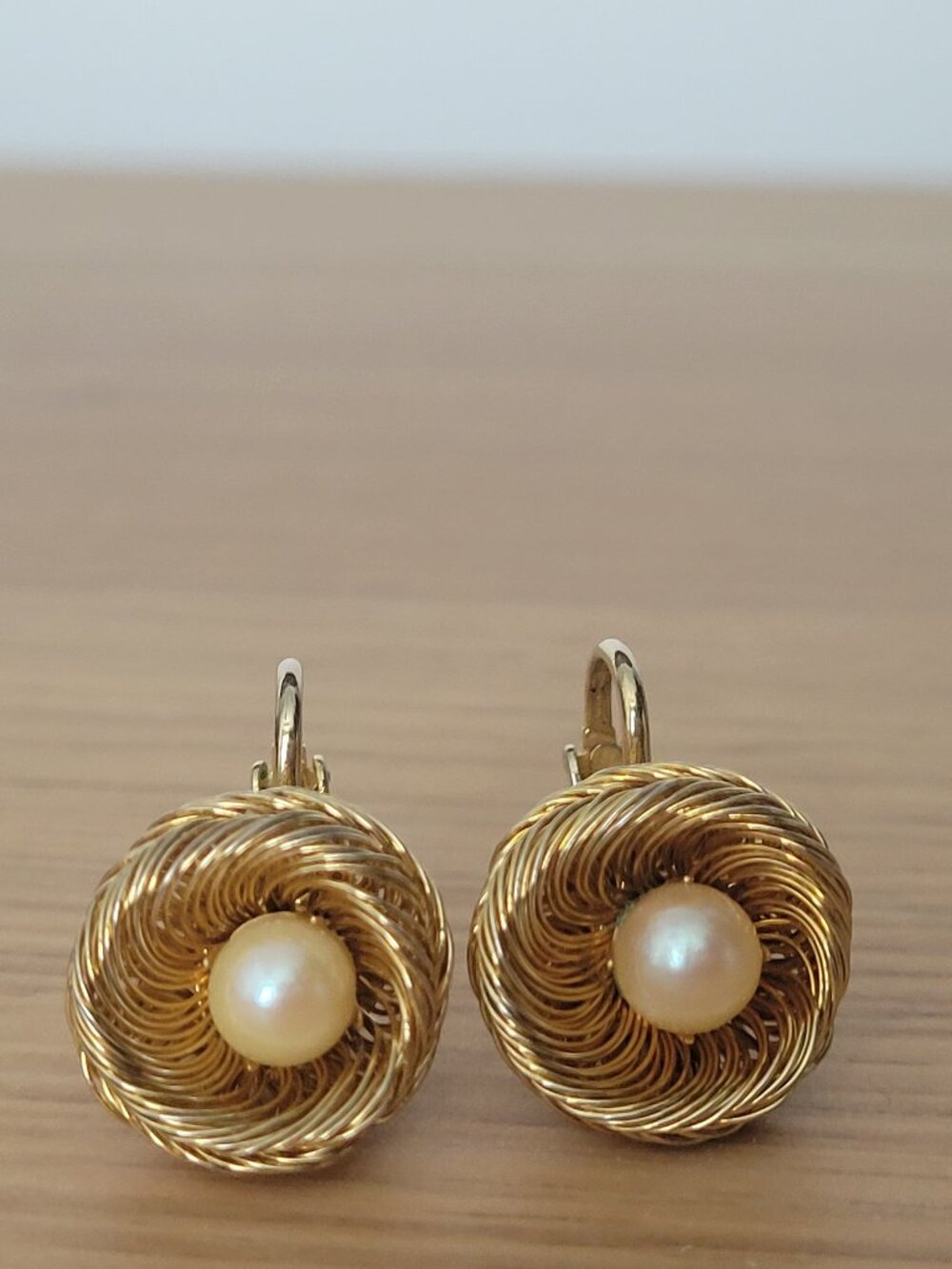 Vintage bird's nest  clip-on earrings feature gold-tone woven wire faux pearl